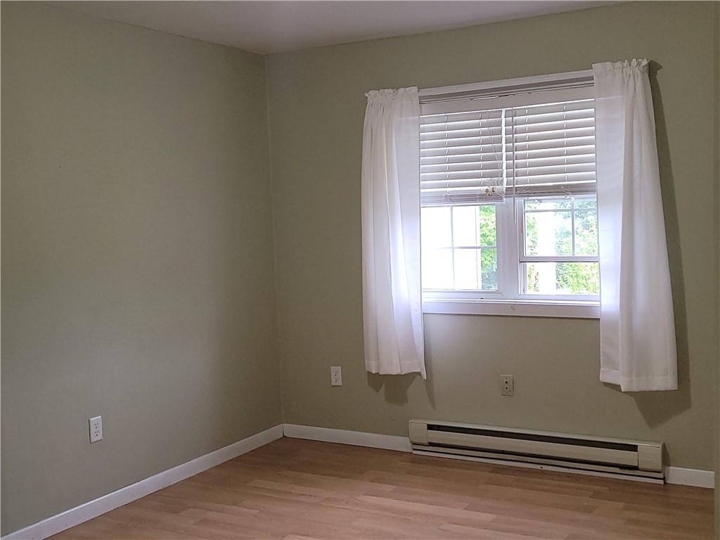 130 Pletcher Road White, PA 15490 - Photo 14 of 22 an empty room with wooden floor and windows