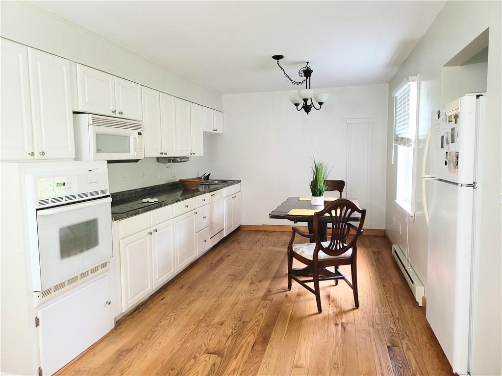 130 Pletcher Road White, PA 15490 - Photo 7 of 22 a kitchen with granite countertop white cabinets and white appliances
