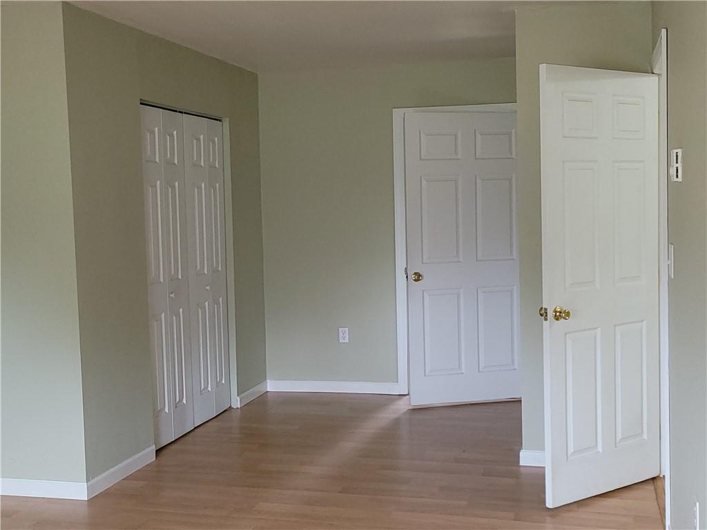 130 Pletcher Road White, PA 15490 - Photo 9 of 22 an empty room with wooden floor and closet area