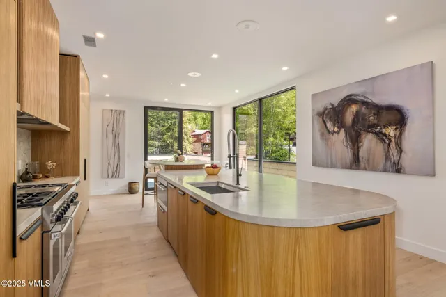 a view of a house with a big yard plants and large trees