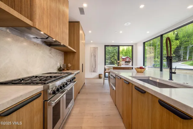 a view of a house with a yard and a fountain