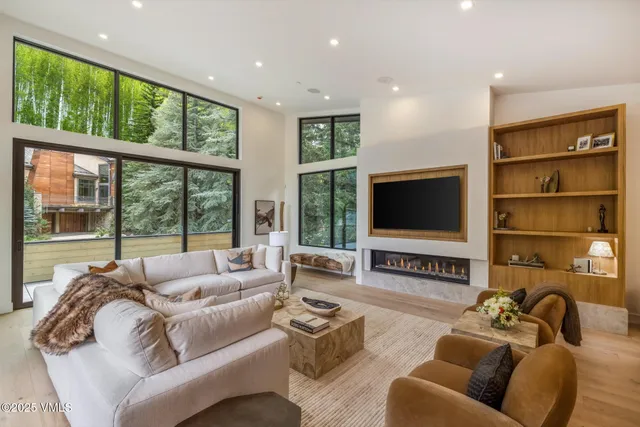 a view of a patio with table and chairs with wooden floor and fence