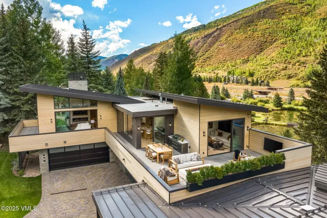 a living room with fireplace furniture and a large window