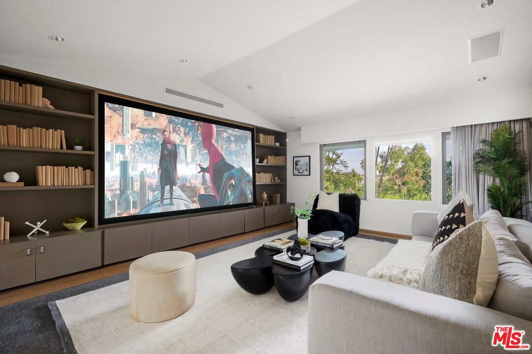 11496 Orum Road Los Angeles, CA 90049 - Photo 11 of 30 a living room with furniture and a flat screen tv