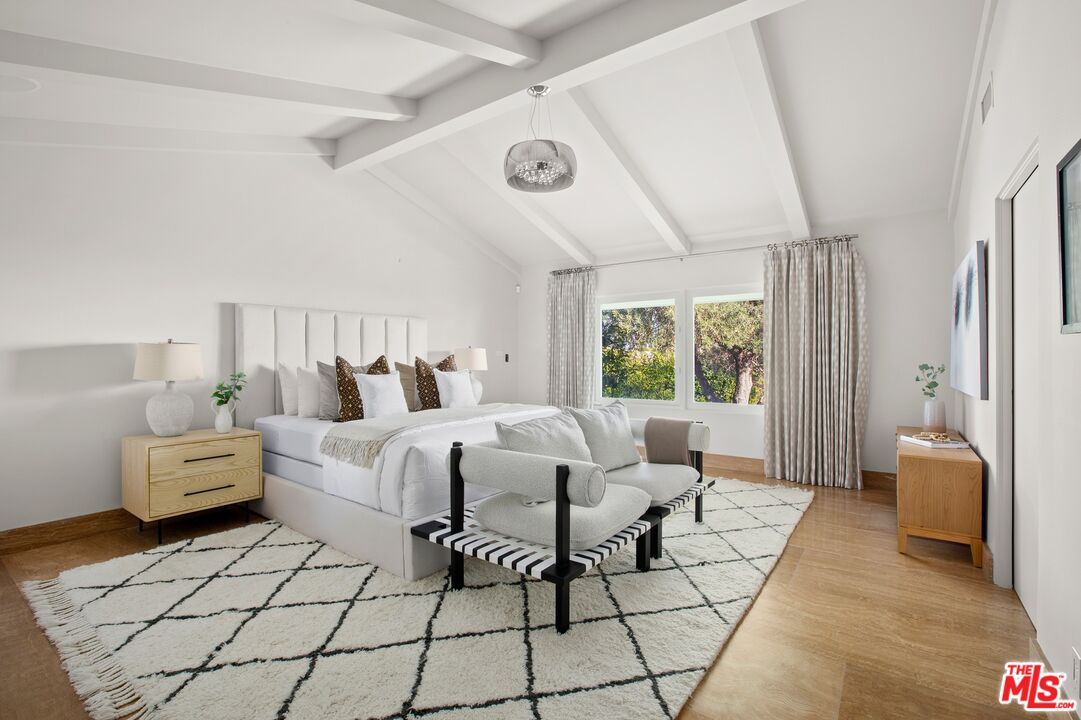 11496 Orum Road Los Angeles, CA 90049 - Photo 12 of 30 a bed room with a bed and a couch