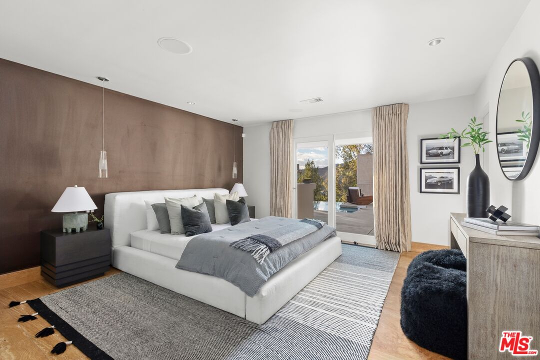 11496 Orum Road Los Angeles, CA 90049 - Photo 14 of 30 a living room with a bed furniture and a window