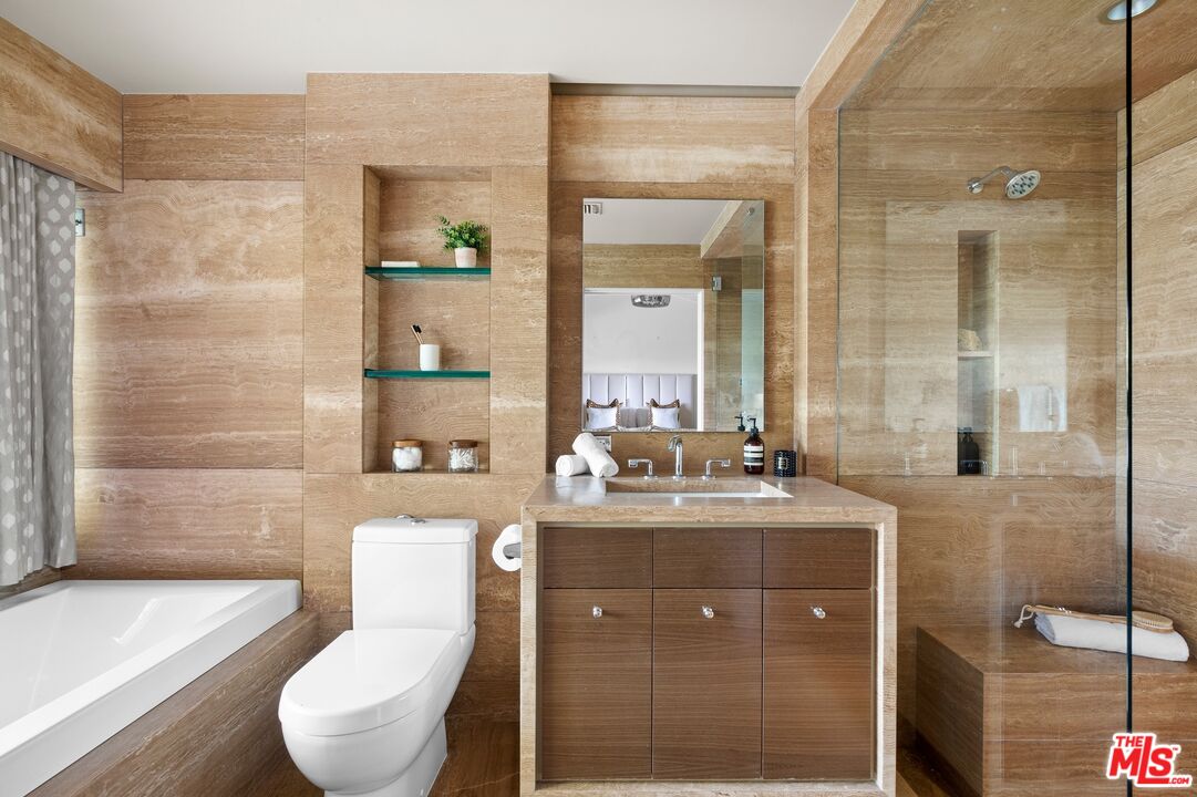 11496 Orum Road Los Angeles, CA 90049 - Photo 15 of 30 a bathroom with a toilet a sink and mirror