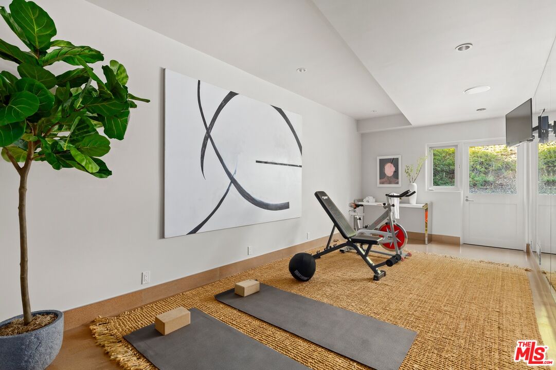 11496 Orum Road Los Angeles, CA 90049 - Photo 16 of 30 a view of a workspace with furniture and a potted plant