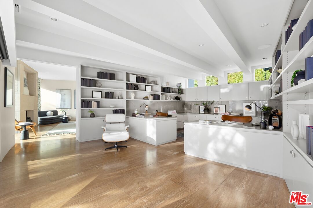 11496 Orum Road Los Angeles, CA 90049 - Photo 18 of 30 a living room with fireplace furniture and a view of kitchen