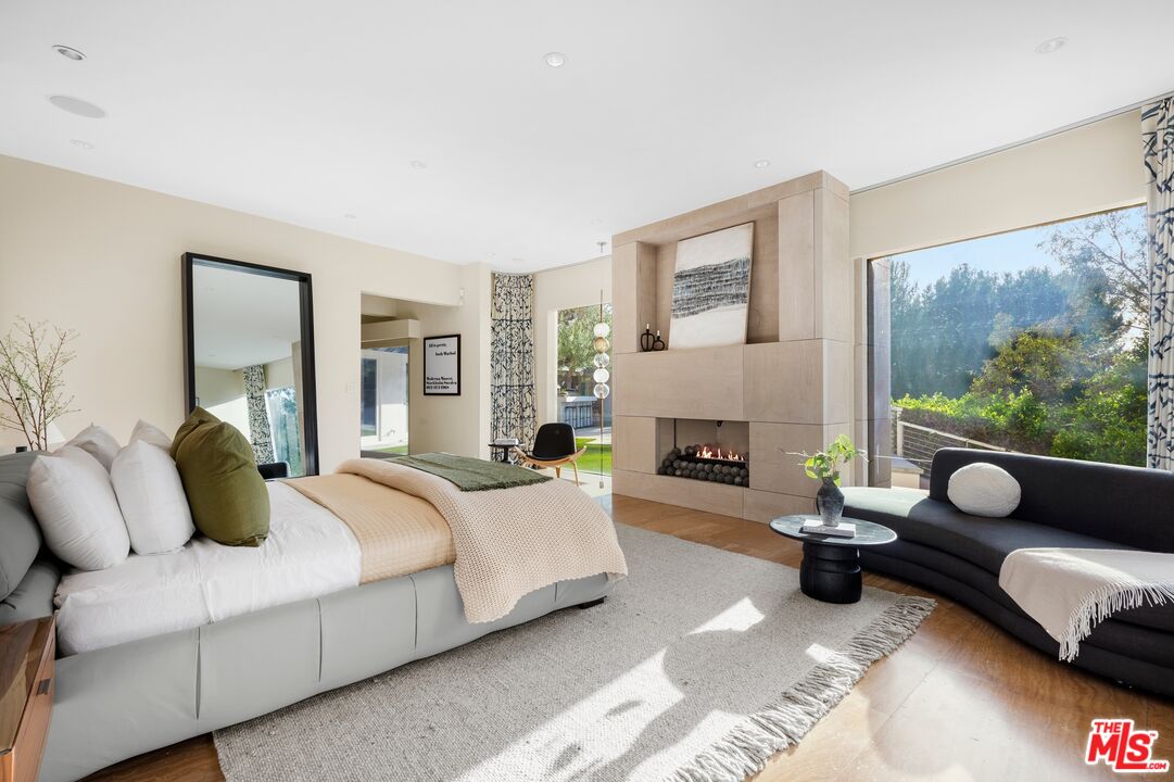 11496 Orum Road Los Angeles, CA 90049 - Photo 22 of 30 a spacious bedroom with a bed and a couch
