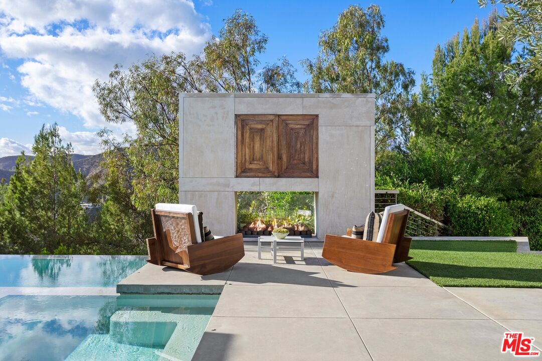 11496 Orum Road Los Angeles, CA 90049 - Photo 27 of 30 a view of a patio with couches and a table and chairs with wooden fence