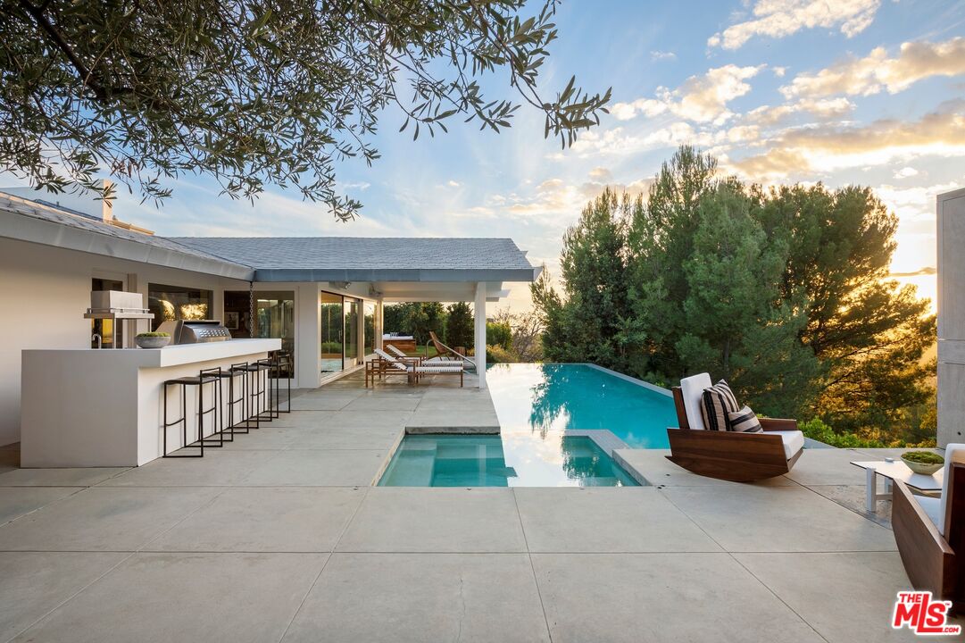 11496 Orum Road Los Angeles, CA 90049 - Photo 28 of 30 a view of a patio with couches table and chairs and potted plants