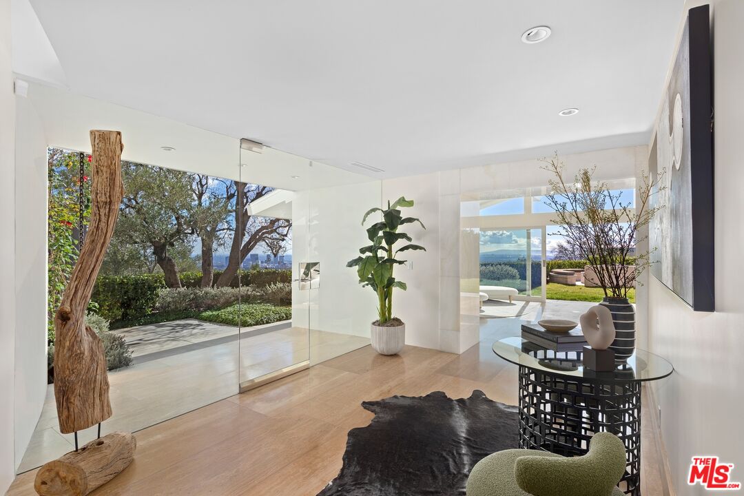 11496 Orum Road Los Angeles, CA 90049 - Photo 4 of 30 a living room with furniture and a floor to ceiling window