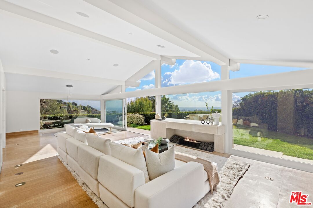 11496 Orum Road Los Angeles, CA 90049 - Photo 8 of 30 a living room with furniture and a floor to ceiling window