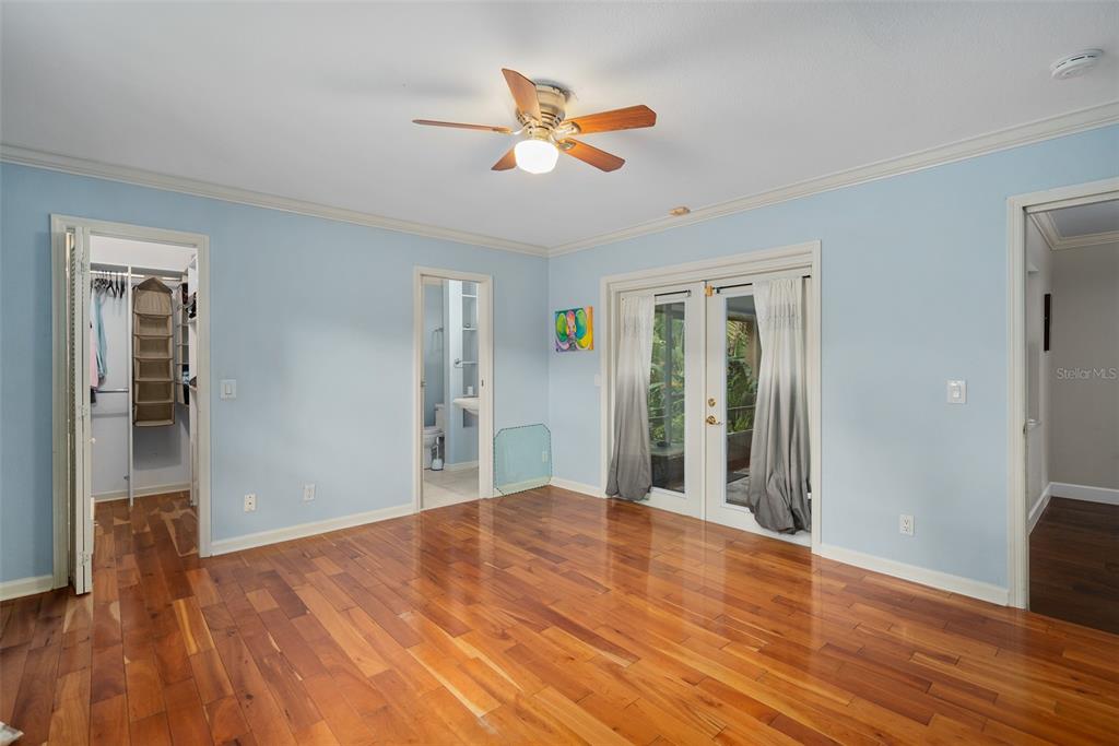 744 Cornwall Road Winter Park, FL 32792 - Photo 17 of 57 a view of a livingroom with wooden floor and a ceiling fan