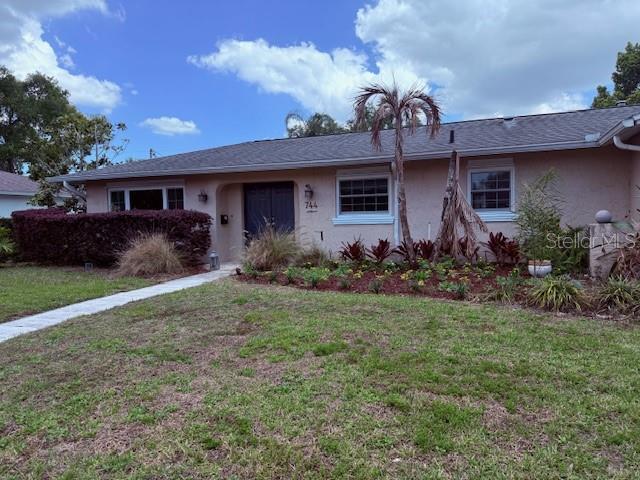 744 Cornwall Road Winter Park, FL 32792 - Photo 2 of 57 a front view of house with yard and trees
