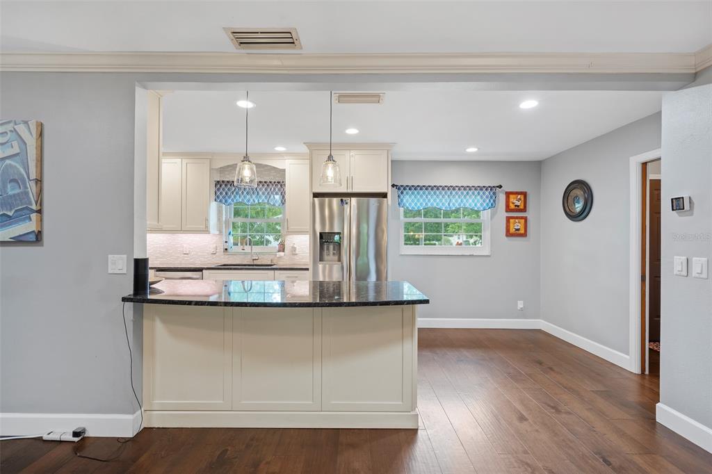 744 Cornwall Road Winter Park, FL 32792 - Photo 3 of 57 a kitchen with kitchen island granite countertop a refrigerator and a sink