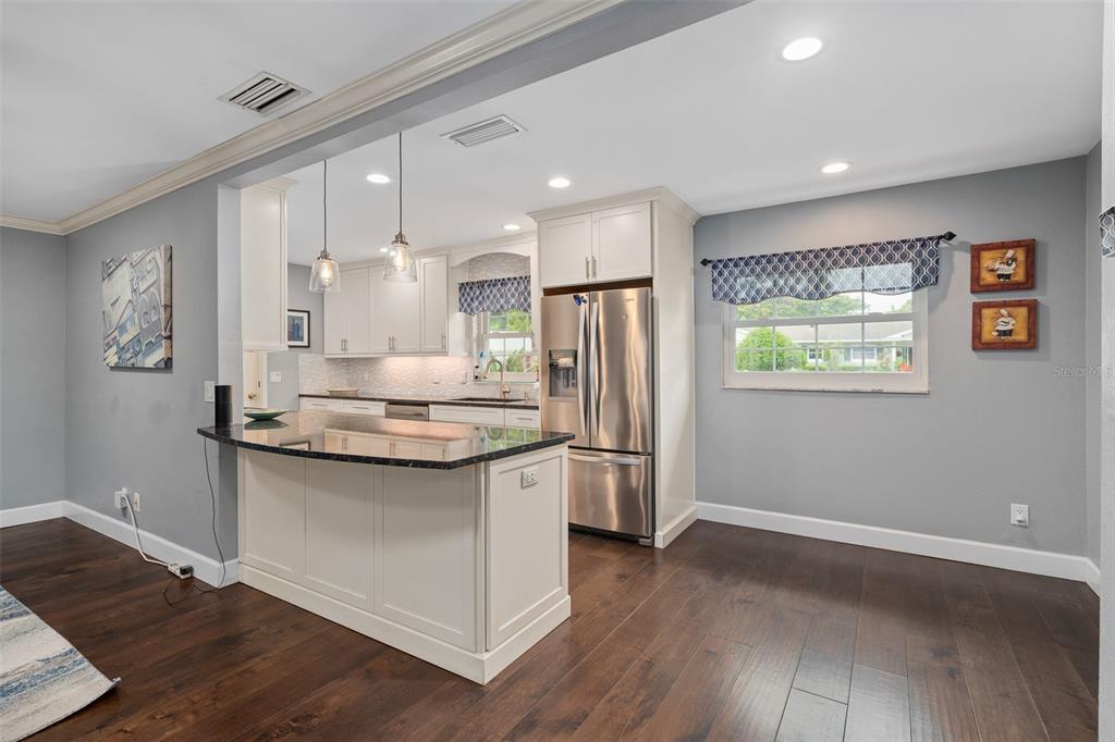 744 Cornwall Road Winter Park, FL 32792 - Photo 6 of 33 a kitchen with stainless steel appliances granite countertop a sink stove and refrigerator