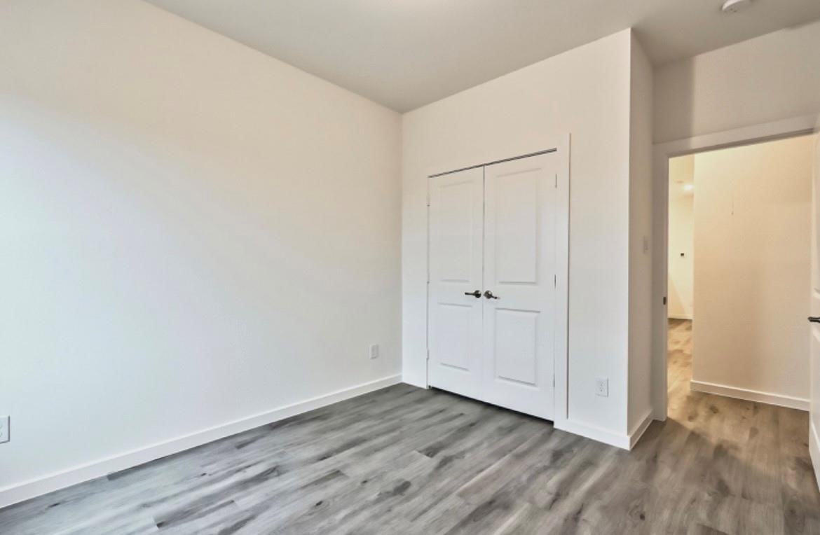 4811 Dig Dug Lane, Unit B Houston, TX 77048 - Photo 15 of 19 a view of an empty room with wooden floor