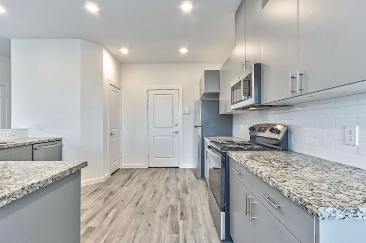 4811 Dig Dug Lane, Unit B Houston, TX 77048 - Photo 7 of 19 a kitchen that has a lot of cabinets in it
