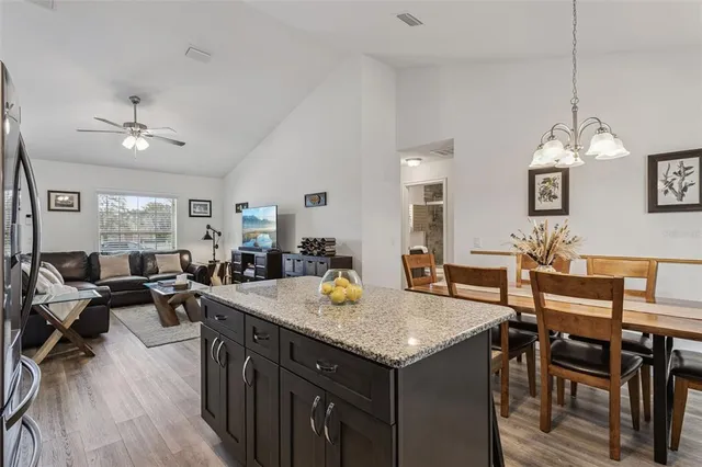a view of a dining room with furniture a chandelier and wooden floor