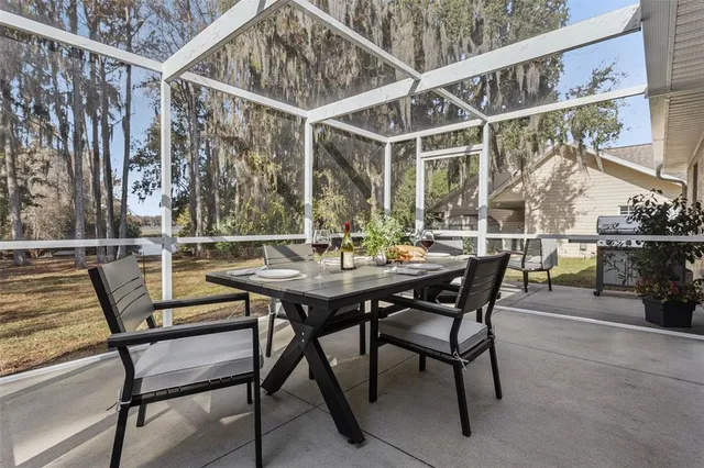 a view of a patio with table and chairs and potted plants