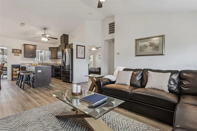 a view of a living room with furniture and wooden floor