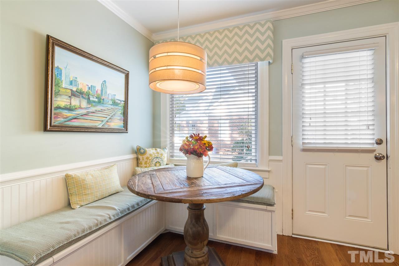 6304 Wynbrook Way Raleigh, NC 27612 - Photo 14 of 30 a living room with furniture a table and a chandelier