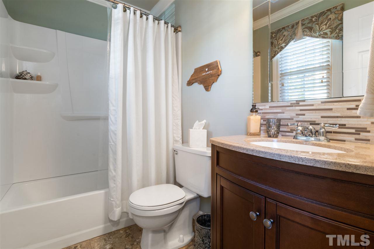 6304 Wynbrook Way Raleigh, NC 27612 - Photo 23 of 30 a bathroom with a sink a toilet and shower