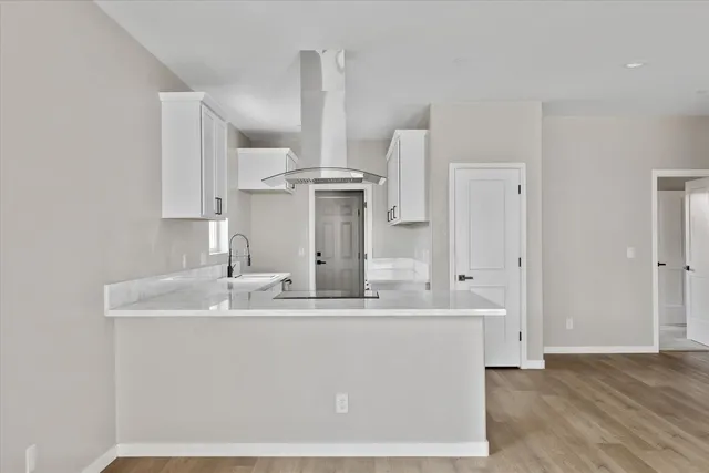 a kitchen with stainless steel appliances granite countertop a stove and a sink with cabinets