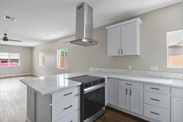 a kitchen with a sink stove and cabinets