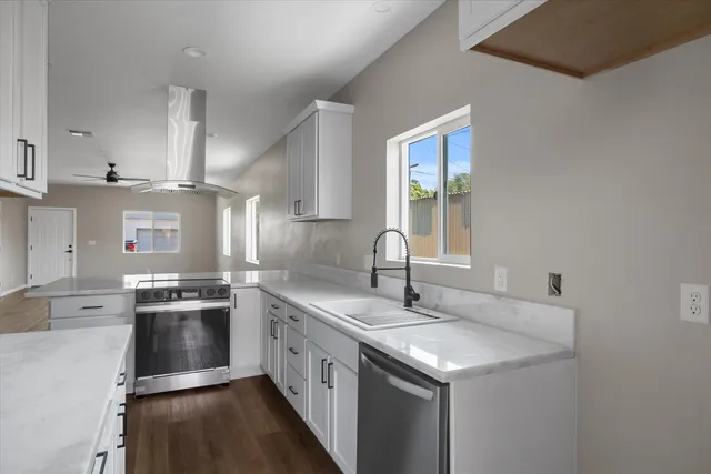 a kitchen with a sink stove and cabinets