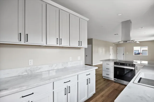 a kitchen with a sink and a stove top oven