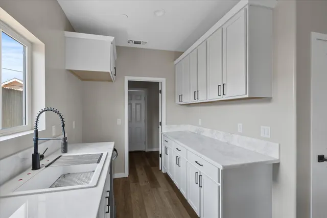 an empty room with a window and a fan