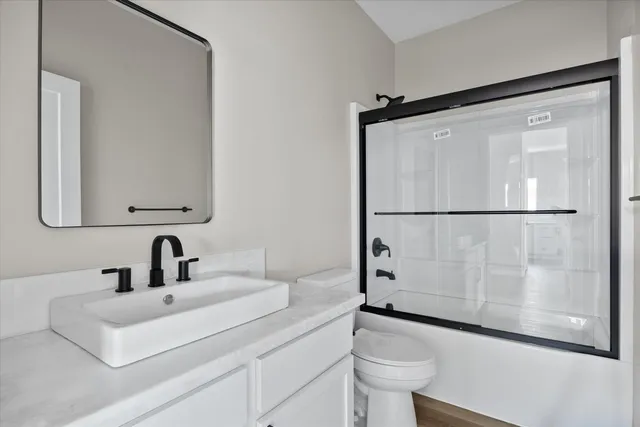 a picture of a bathroom with a door