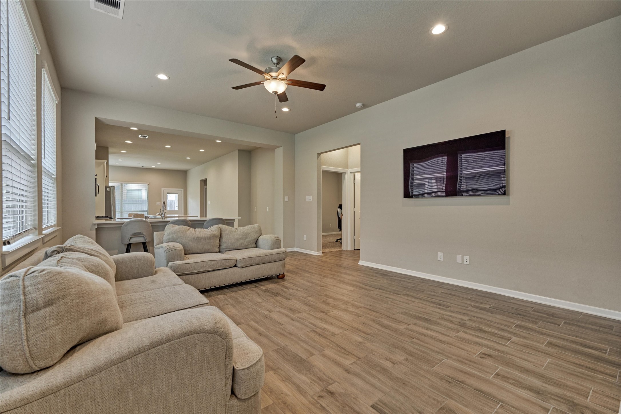 10545 Wild Chives Conroe, TX 77385 - Photo 11 of 34 a living room with furniture and a chandelier