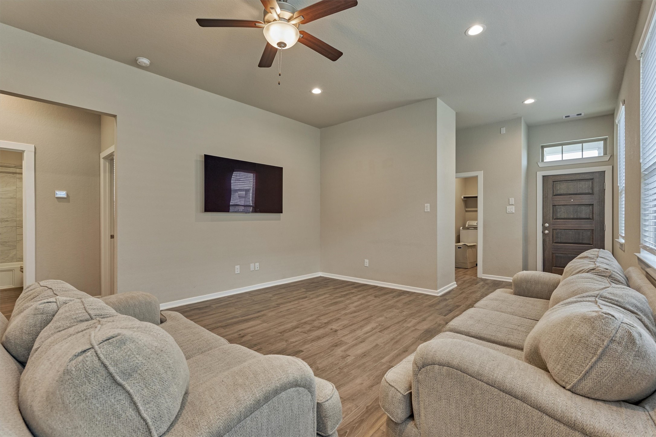 10545 Wild Chives Conroe, TX 77385 - Photo 15 of 34 a living room with furniture and a ceiling fan