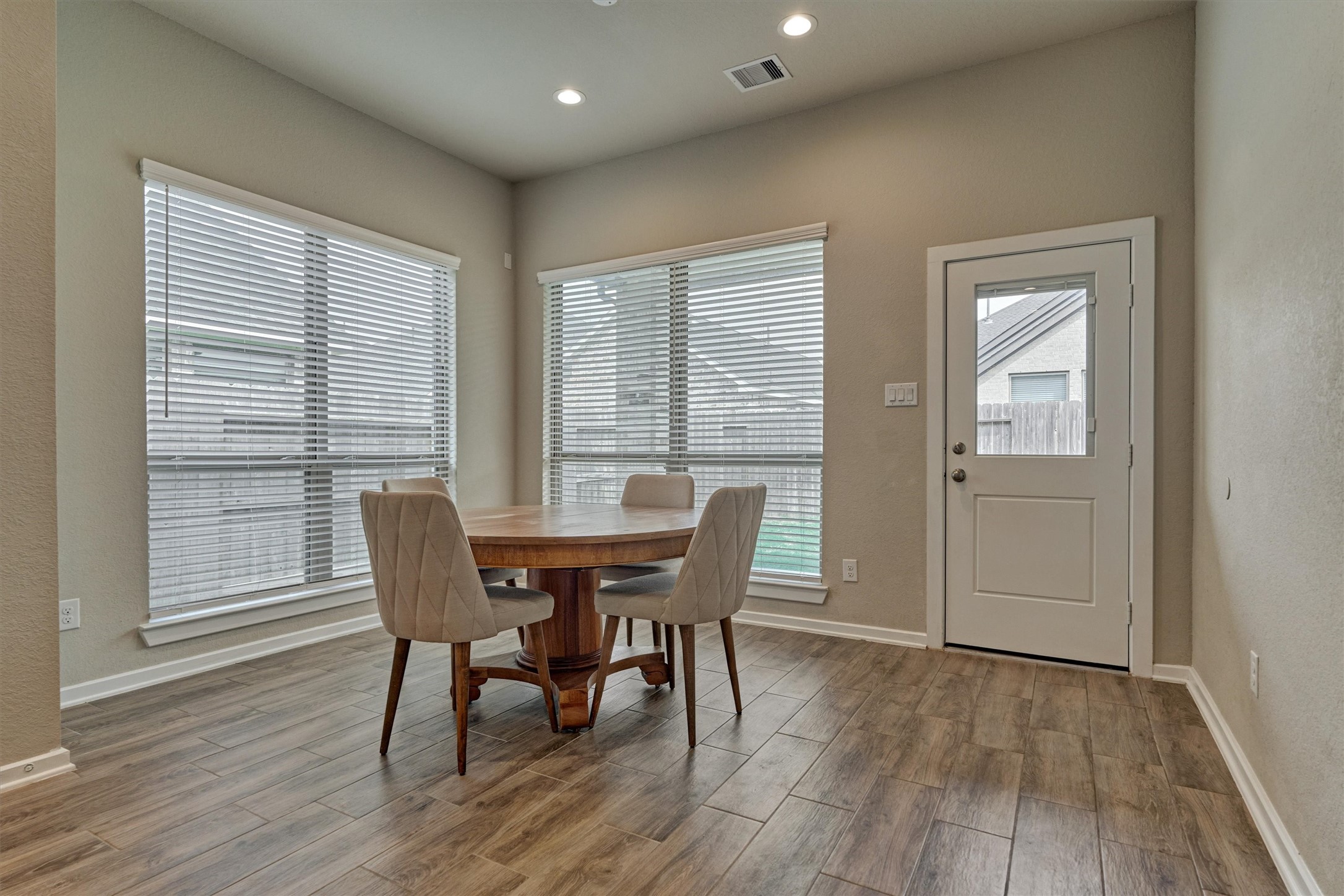 10545 Wild Chives Conroe, TX 77385 - Photo 20 of 34 a view of a dining room with furniture and wooden floor