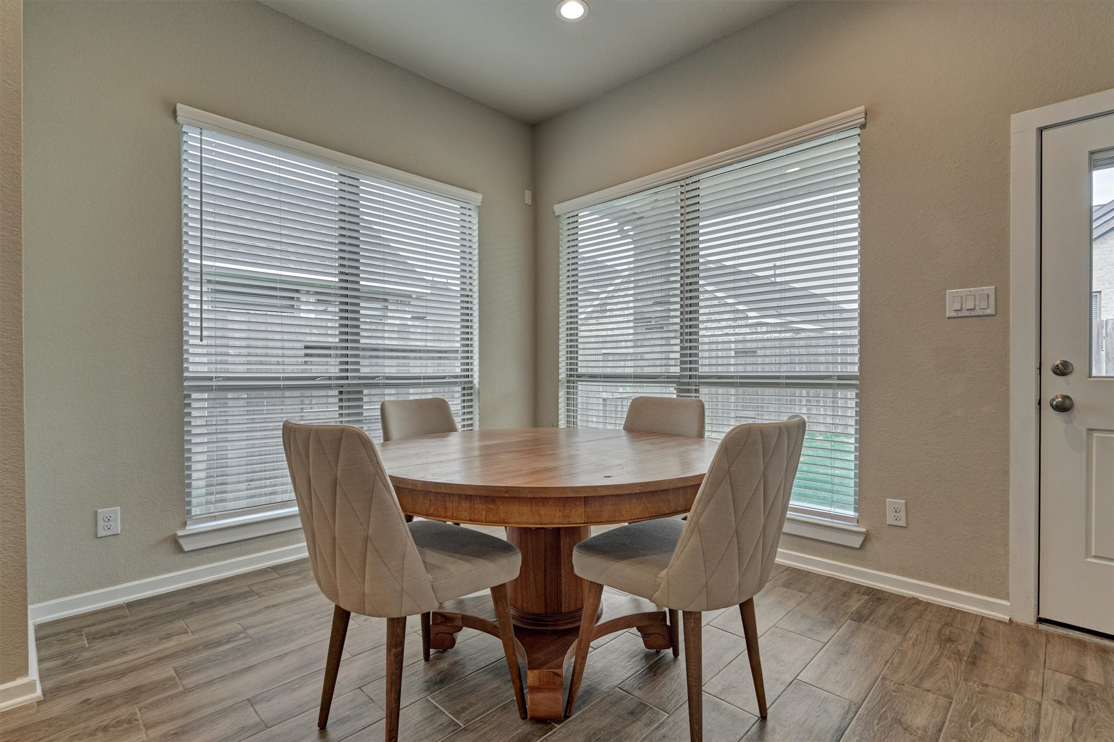 10545 Wild Chives Conroe, TX 77385 - Photo 21 of 34 a view of a dining room with furniture and wooden floor