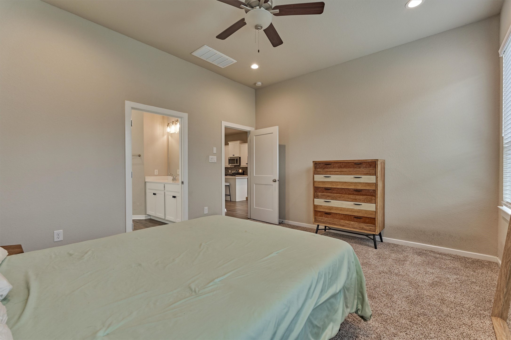 10545 Wild Chives Conroe, TX 77385 - Photo 24 of 34 a bedroom with a bed and a chandelier