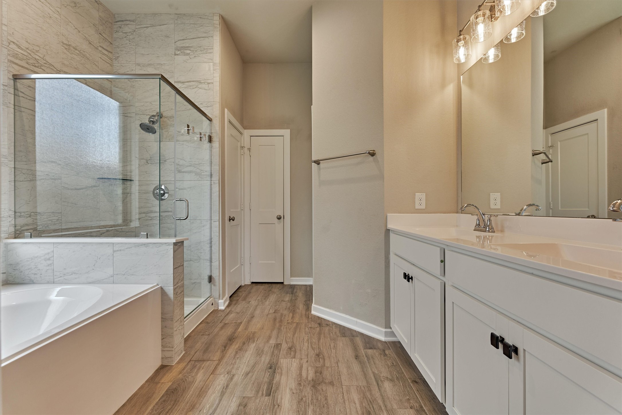 10545 Wild Chives Conroe, TX 77385 - Photo 7 of 34 a bathroom with a sink a mirror and a bathtub