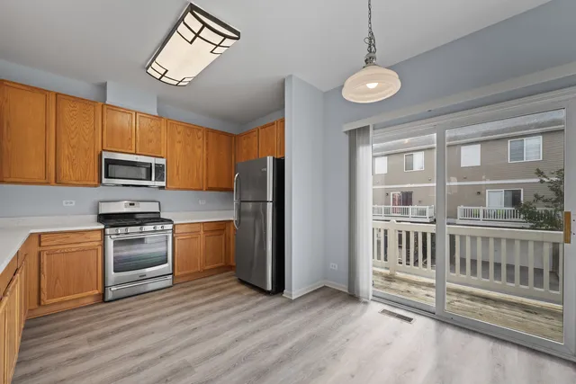 a kitchen with stainless steel appliances granite countertop a stove and a refrigerator