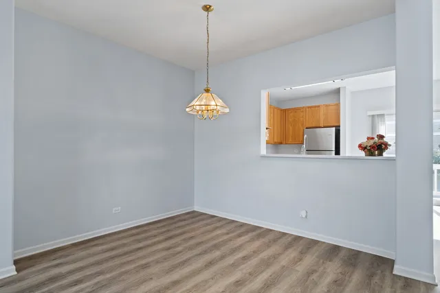 a view of a room with wooden floor and chandelier
