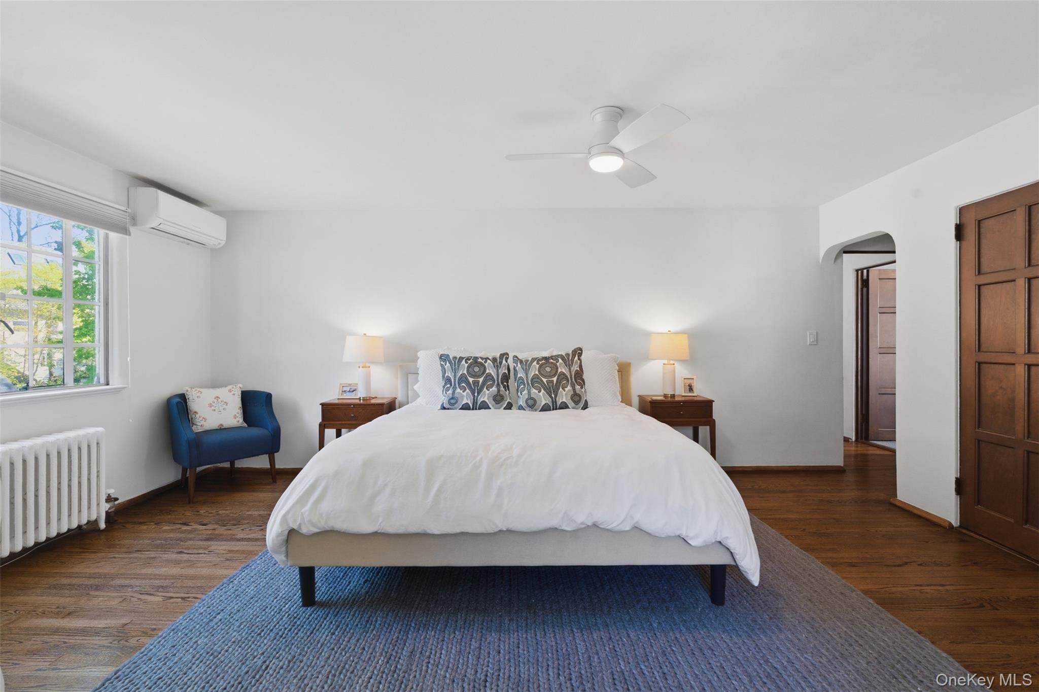 15 Kingsbury Road New Rochelle, NY 10804 - Photo 17 of 30 a bedroom with a bed wooden floor and window