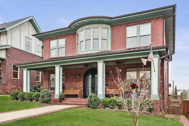 a living room with furniture a window and a flat screen tv