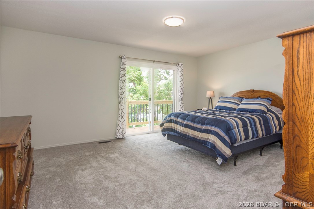 749 Lucy Road Lake Ozark, MO 65049 - Photo 11 of 27 Large second bedroom. Sliding door leads out to th