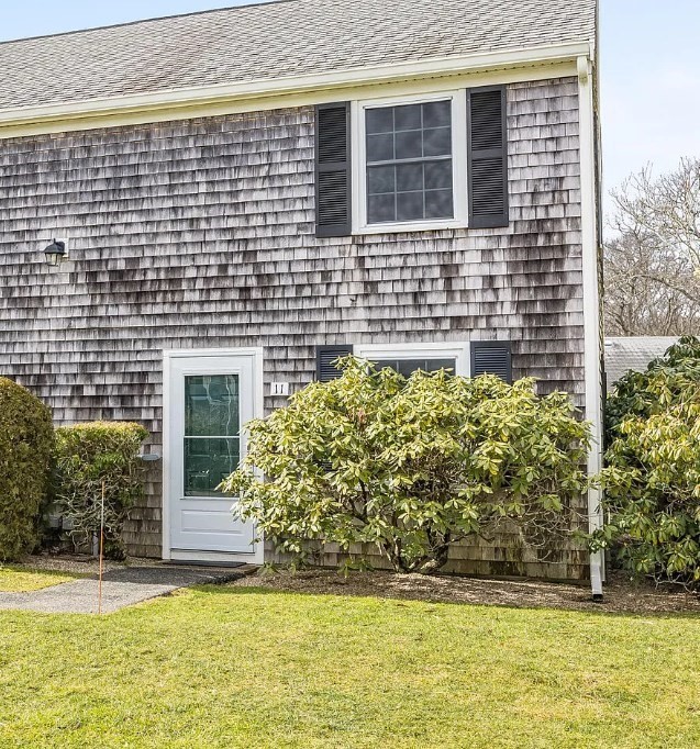 135 West Main Street, Unit 11 Barnstable, MA 02601 - Photo 1 of 11 a front view of a house with a yard