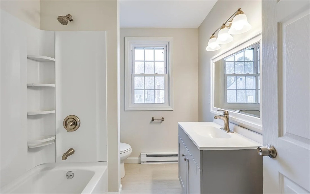 135 West Main Street, Unit 11 Barnstable, MA 02601 - Photo 11 of 11 a bathroom with a granite countertop sink a toilet and shower