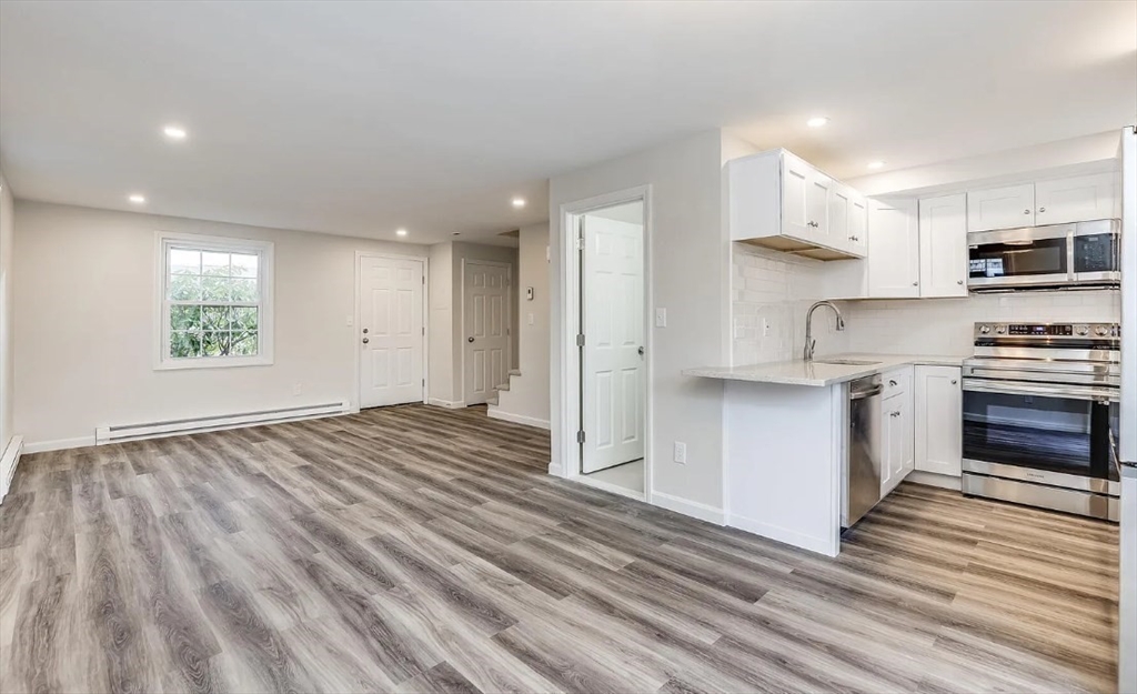 135 West Main Street, Unit 11 Barnstable, MA 02601 - Photo 2 of 11 a view of kitchen with wooden floor electronic appliances and window