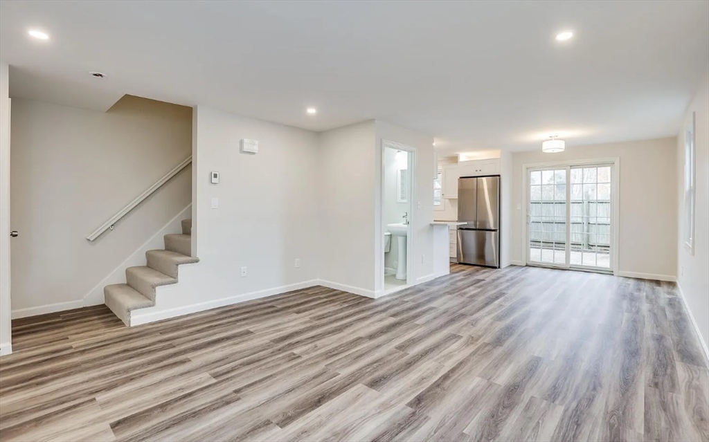 135 West Main Street, Unit 11 Barnstable, MA 02601 - Photo 3 of 11 a view of empty room with wooden floor and fan